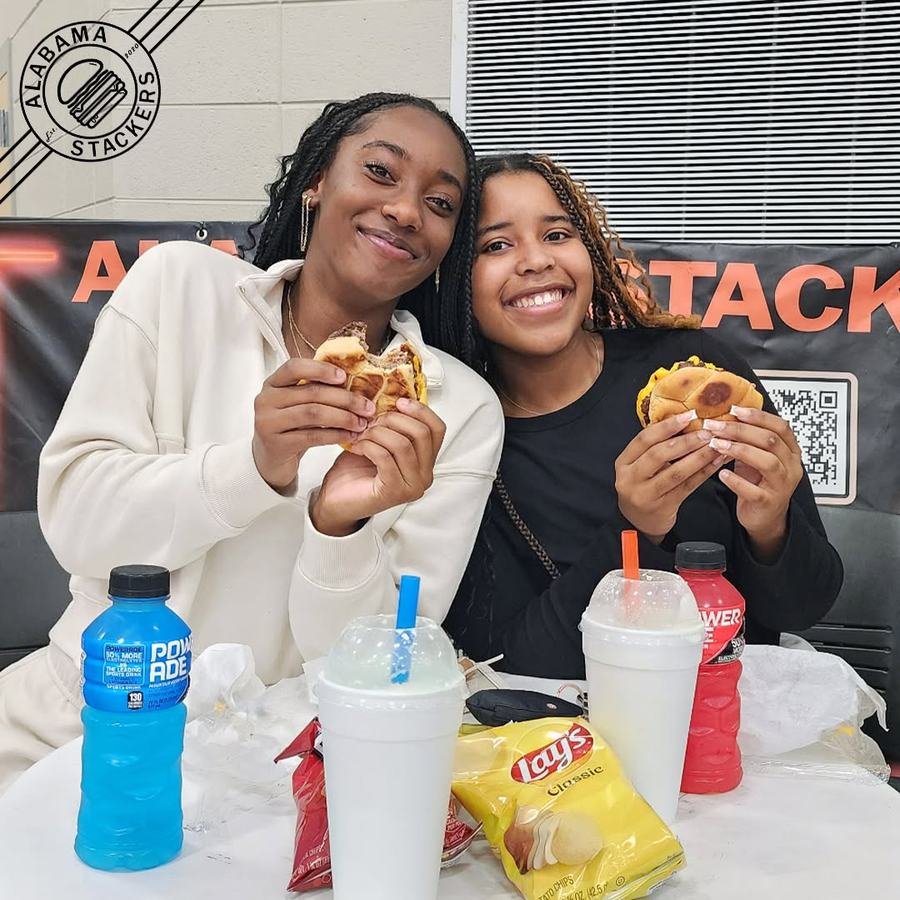 Two friends with burgers and shakes