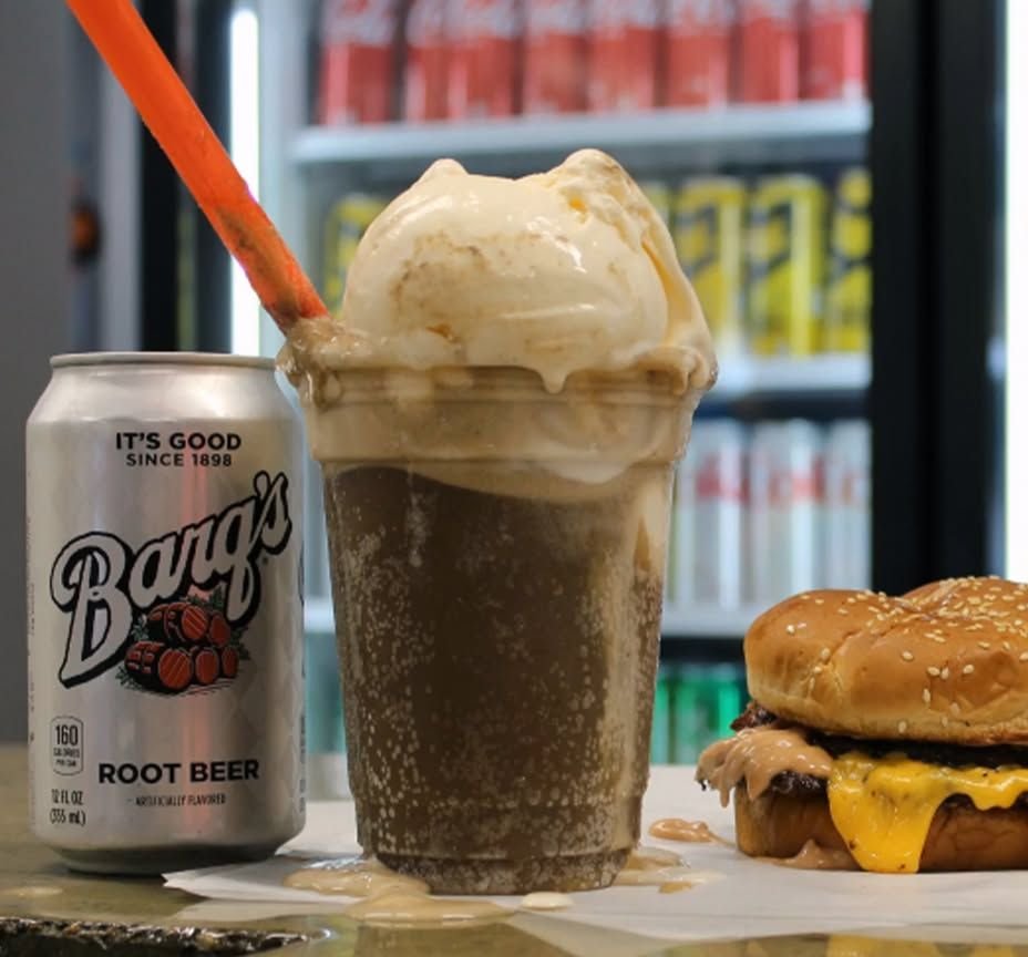 Root beer float next to a cheeseburger