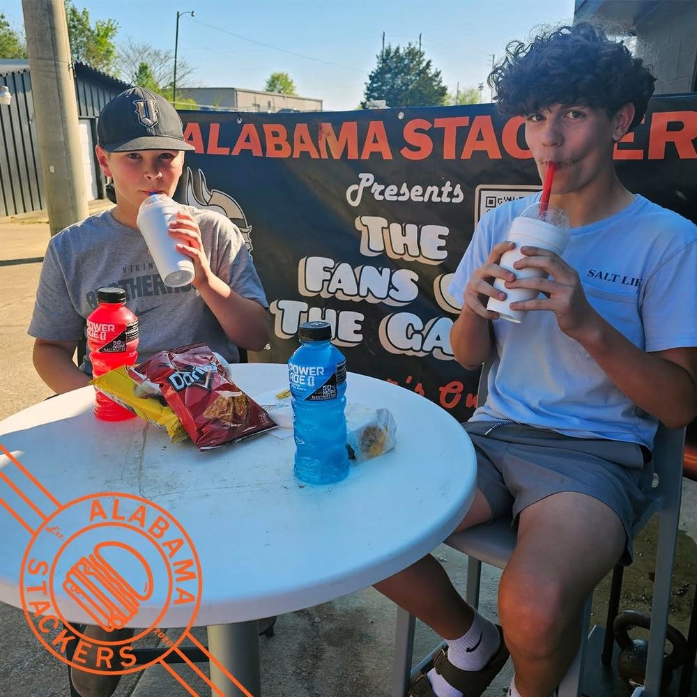 Two boys with burgers and drinks
