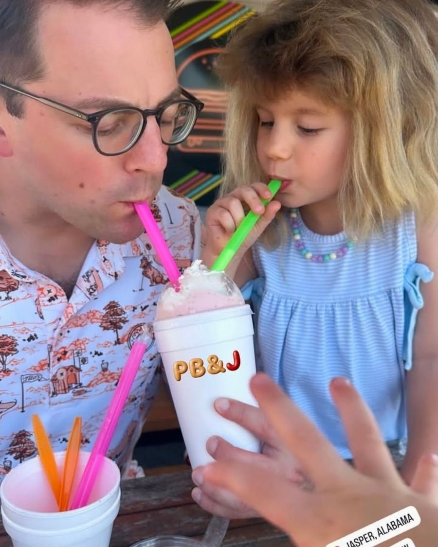 A dad and daughter sharing a PB&J milkshake
