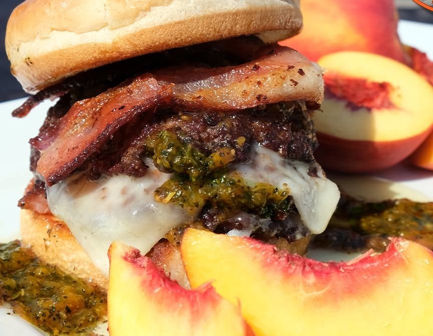 Peach Pesto burger with fried peaches, fresh pesto and bacon
